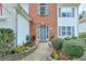 Inviting entrance with a well-manicured garden, charming bushes, and a red brick pathway leading to the front door at 3060 Baymount Dr, Lawrenceville, GA 30043