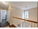 Upstairs hallway with railing overlooking the front entry, a pendant light, and a linen closet at 3060 Baymount Dr, Lawrenceville, GA 30043
