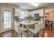 A kitchen featuring white cabinets, granite countertops, stainless steel appliances, and an eat-in island at 3060 Baymount Dr, Lawrenceville, GA 30043