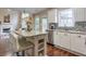 Bright kitchen with white cabinets, granite countertops, stainless steel appliances, and eat-in kitchen island at 3060 Baymount Dr, Lawrenceville, GA 30043