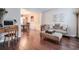 Comfortable living area with hardwood floors, neutral walls, and stylish furnishings including a sofa, ottoman, and desk at 3060 Baymount Dr, Lawrenceville, GA 30043