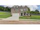 Charming two-story brick home featuring a well-manicured lawn and a two-car garage at 1109 Georgian Point Dr, Lawrenceville, GA 30045