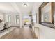 Spacious foyer with hardwood floors, a large mirror, and an open doorway to the outside at 1109 Georgian Point Dr, Lawrenceville, GA 30045
