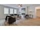 Bright living room features three large windows, wood flooring, modern decor, and a cozy electric fireplace at 1109 Georgian Point Dr, Lawrenceville, GA 30045