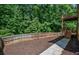 View of the fenced backyard and wooden deck, ideal for outdoor activities and privacy at 1185 Gallatin Way, Suwanee, GA 30024