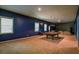 Large basement with a pool table, natural light from windows, and comfortable seating at 1185 Gallatin Way, Suwanee, GA 30024