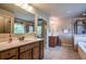 Bright, dual-vanity bathroom with tiled floors and a glass-enclosed shower at 1185 Gallatin Way, Suwanee, GA 30024