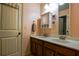 Bathroom with double sinks, wooden cabinets, and neutral wall color at 1185 Gallatin Way, Suwanee, GA 30024