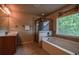 Bright bathroom featuring a soaking tub with a shower, and a cherry wood vanity with a countertop sink at 1185 Gallatin Way, Suwanee, GA 30024
