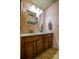 Bathroom featuring double sinks, a vanity, and wall cabinet with decorative touches at 1185 Gallatin Way, Suwanee, GA 30024