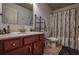 Neutral bathroom with a sink, shower with curtain, and toilet at 1185 Gallatin Way, Suwanee, GA 30024