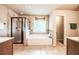 Bright bathroom with a glass shower, tub, and dual vanities at 1185 Gallatin Way, Suwanee, GA 30024