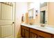 Bathroom featuring a double vanity, mirrors, and linen closet at 1185 Gallatin Way, Suwanee, GA 30024