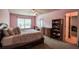 Comfortable bedroom with ceiling fan, a double bed, and dresser at 1185 Gallatin Way, Suwanee, GA 30024