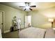 Bright bedroom with a ceiling fan, striped bedding and stylish decor at 1185 Gallatin Way, Suwanee, GA 30024