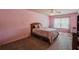 Bright bedroom features a floral comforter on the bed and a ceiling fan for added comfort at 1185 Gallatin Way, Suwanee, GA 30024