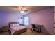 Comfortable bedroom with a bed, desk, chair, and neutral colors at 1185 Gallatin Way, Suwanee, GA 30024