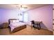 Purple bedroom featuring bed, nightstands, desk, and carpet floors at 1185 Gallatin Way, Suwanee, GA 30024