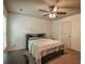 Bedroom with ceiling fan offers natural light, neutral walls, and dark wood furniture at 1185 Gallatin Way, Suwanee, GA 30024