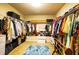 Walk-in closet with custom shelving, storage boxes and hanging rods for organization at 1185 Gallatin Way, Suwanee, GA 30024