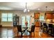 Dining area with glass-topped table, chairs, and access to the kitchen and outdoor patio at 1185 Gallatin Way, Suwanee, GA 30024