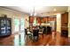 Dining area with view to kitchen island, eat-in bar, and access to an outdoor patio at 1185 Gallatin Way, Suwanee, GA 30024