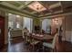 Elegant dining room featuring hardwood floors and a coffered ceiling near living room at 1185 Gallatin Way, Suwanee, GA 30024