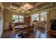 Formal dining room with coffered ceiling, decorative chandelier, and large windows at 1185 Gallatin Way, Suwanee, GA 30024