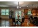 Open concept dining area with hardwood floors, chandelier, and view of the modern kitchen at 1185 Gallatin Way, Suwanee, GA 30024