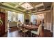 Dining room with coffered ceilings, hardwood floors, and open view to living room at 1185 Gallatin Way, Suwanee, GA 30024