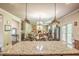 Open-concept kitchen with stone countertops, island, and sight lines to the living room and outdoor spaces at 1185 Gallatin Way, Suwanee, GA 30024