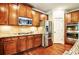 A stylish kitchen with stainless steel appliances and granite countertops and custom wood cabinets at 1185 Gallatin Way, Suwanee, GA 30024