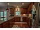 Traditional kitchen with granite counters, wood cabinets, and stainless steel appliances at 1185 Gallatin Way, Suwanee, GA 30024