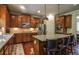Kitchen featuring granite countertops, stainless steel appliances, and dark wood cabinetry and barstool seating at 1185 Gallatin Way, Suwanee, GA 30024