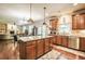 Kitchen with granite island and stainless appliances offers an open view to the living room at 1185 Gallatin Way, Suwanee, GA 30024