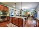 Open kitchen with granite island, stainless appliances and view of living room at 1185 Gallatin Way, Suwanee, GA 30024