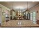 Open-concept kitchen with granite countertops and stainless steel appliances overlooking the spacious living room area at 1185 Gallatin Way, Suwanee, GA 30024