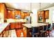 Kitchen with wood cabinets, stainless appliances, and granite countertop island at 1185 Gallatin Way, Suwanee, GA 30024