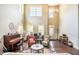 Open living room featuring soaring ceilings, elegant decor, and plenty of natural light at 1185 Gallatin Way, Suwanee, GA 30024
