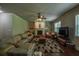 Comfortable living room featuring a fireplace, large sectional sofa, and a ceiling fan at 1185 Gallatin Way, Suwanee, GA 30024