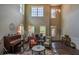 Bright living room with tall ceilings, piano, and colorful rug at 1185 Gallatin Way, Suwanee, GA 30024