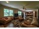 Spacious living room with hardwood floors, large windows, and open to the kitchen at 1185 Gallatin Way, Suwanee, GA 30024
