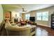 Well-lit living room featuring a fireplace, large windows, and hardwood floors at 1185 Gallatin Way, Suwanee, GA 30024