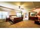 Spacious main bedroom featuring a ceiling fan, en-suite bathroom, and carpet floors at 1185 Gallatin Way, Suwanee, GA 30024