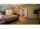This main bedroom features a sitting area, carpeted floors, and an en-suite bath at 1185 Gallatin Way, Suwanee, GA 30024