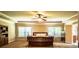 Bright main bedroom with tray ceilings, carpet floors, and natural light from the windows at 1185 Gallatin Way, Suwanee, GA 30024