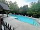 Inviting community pool with ample seating and lush landscaping, perfect for summer relaxation at 1185 Gallatin Way, Suwanee, GA 30024