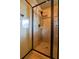 Modern tiled shower with glass door, rain shower head, and built-in shelves for storage at 1185 Gallatin Way, Suwanee, GA 30024