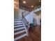 Inviting staircase with hardwood steps, black iron spindles and a view to the second story at 1185 Gallatin Way, Suwanee, GA 30024
