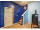 Basement staircase features a mini fridge, and neutral walls at 1185 Gallatin Way, Suwanee, GA 30024
